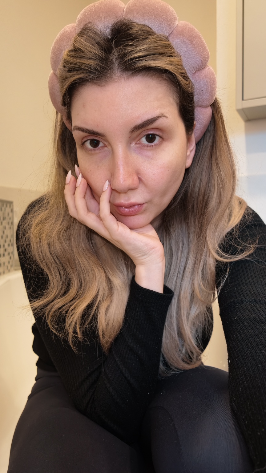 Lena wearing a pink skincare headband
